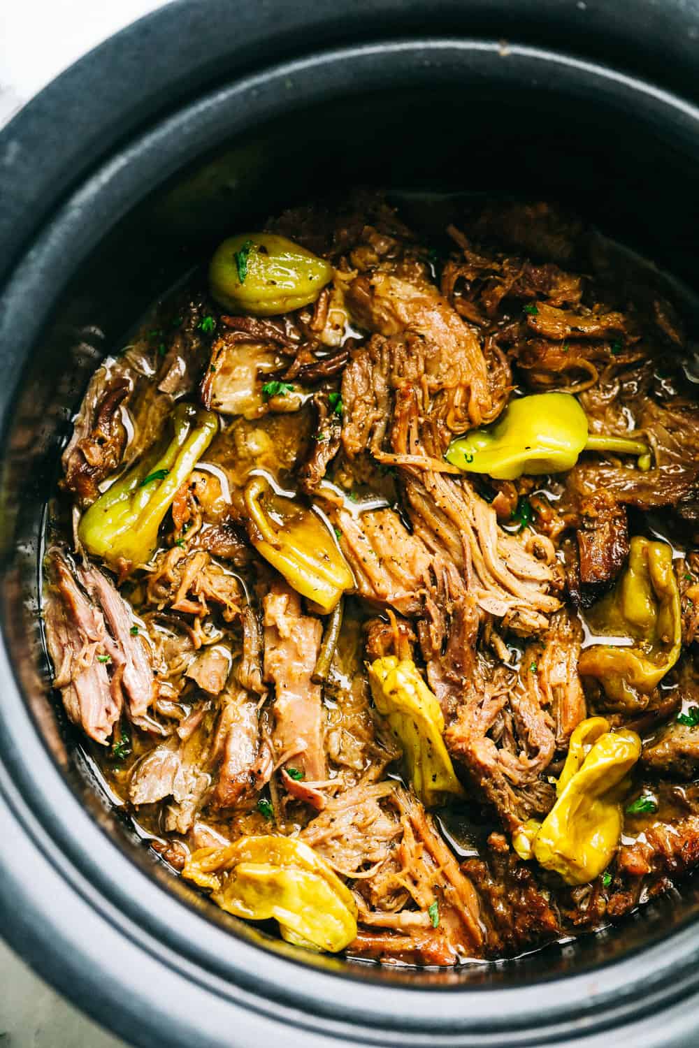 Slow Cooker Mississippi Pork Roastย is a savory, sweet and spicy pork roast that is tender to the touch and falls apart with ease. It takes minutes toย prepare and can be paired with a variety of sides. Your family will fall in love with this incredibly flavorful, melt in your mouth pork roast!ย Finished pork roast in crock pot.