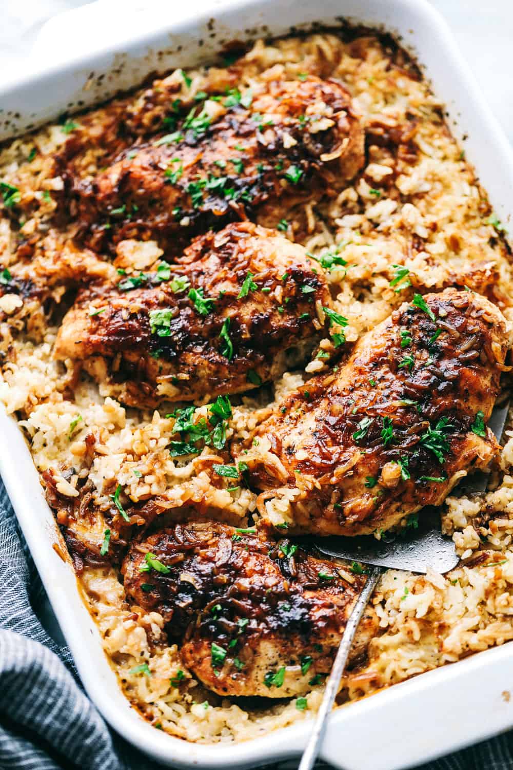 No Peek Chicken and Rice Casseroleย is full of comfort and tender, fall apart chickenย overtopping a flavorful rice thatย makes this meal a family favorite! Baking to perfection with the warm, steamย cooking the chicken and rice to perfection.ย No Peek Chicken and Rice Casserole in a pan.