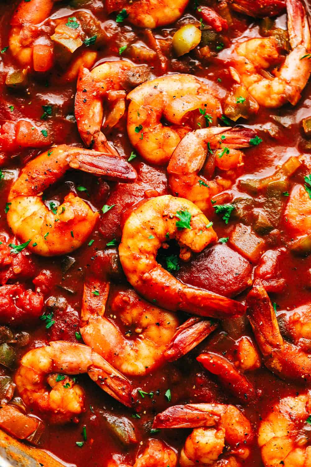 Easy Shrimp Creole is a spicy, chunky tomato and green pepper mixture that coats tender shrimp to make a hearty family meal done right! Your family will be jazzing during dinner with this classic southern meal! Close up on creole shrimp.