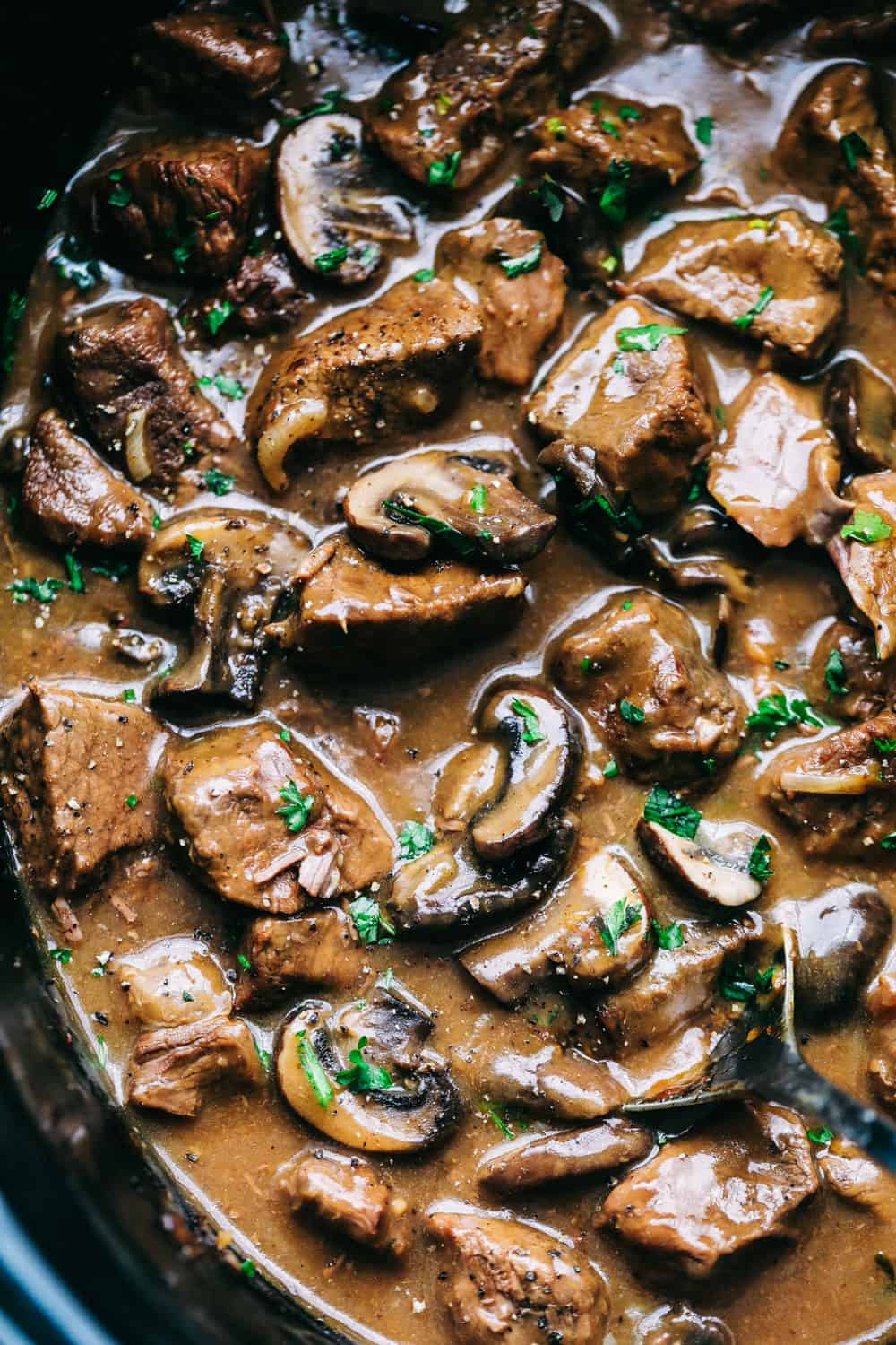Slow Cooker Beef Tips are tender beef slices, mixedย with chopped mushrooms and onion mix slow cooked to perfection! Easy weeknight meal!ย slow cooker beef tips in a slow cooker