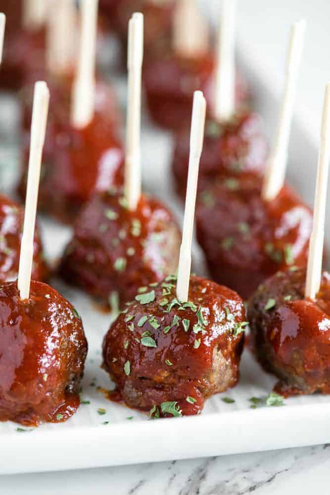 Meatloaf Meatballs are bite sized appetizers that have all the flavor you love in a classic meatloaf recipe. Meatloaf meatballs with toothpicks in them in rows.