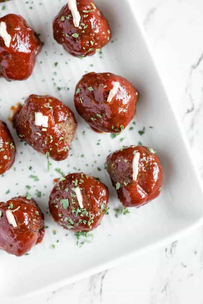 Meatloaf Meatballs are bite sized appetizers that have all the flavor you love in a classic meatloaf recipe. Meatloaf meatballs in rows in a baking pan.