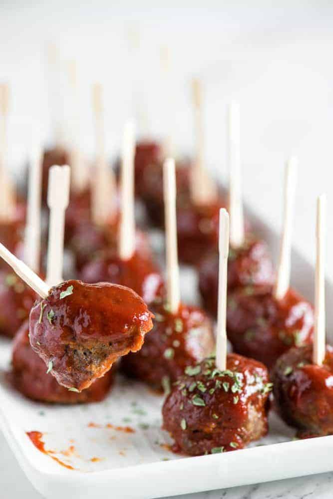 Meatloaf Meatballs are bite sized appetizers that have all the flavor you love in a classic meatloaf recipe. Picking up a meatball out of a row of meatballs