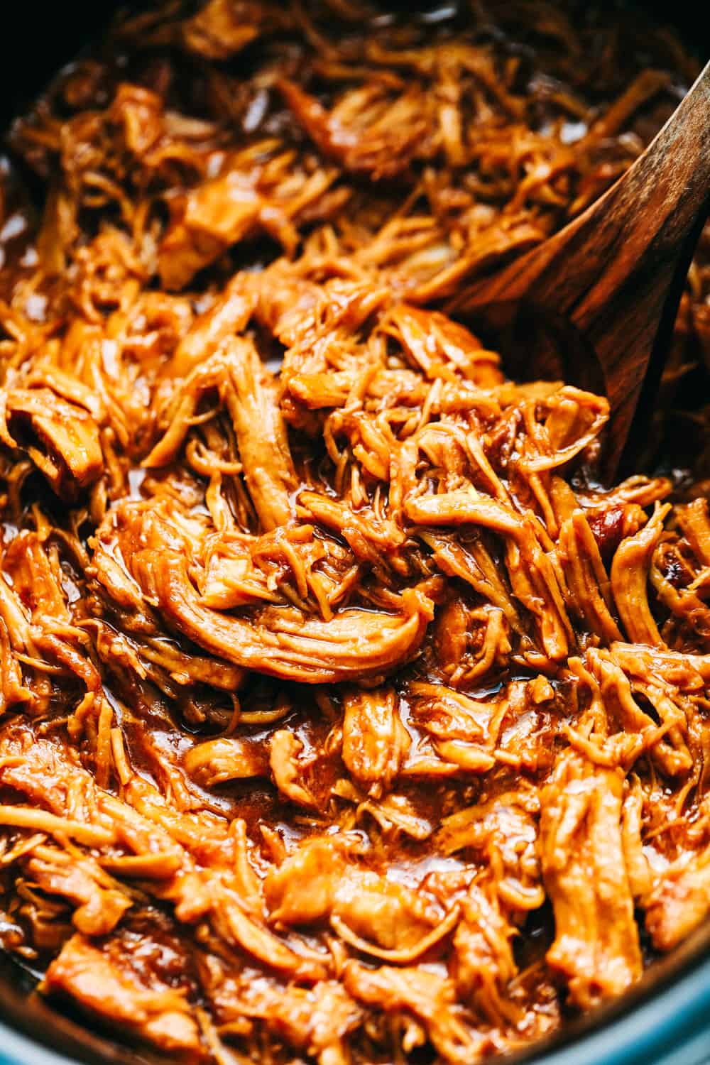 Slow Cooker BBQ Chicken slow cooks to perfection in the best sweet and tangy homemade BBQ sauce. The chicken is so tender and just melts in your mouth with the most amazing flavor! Close up of shredded BBQ chicken.