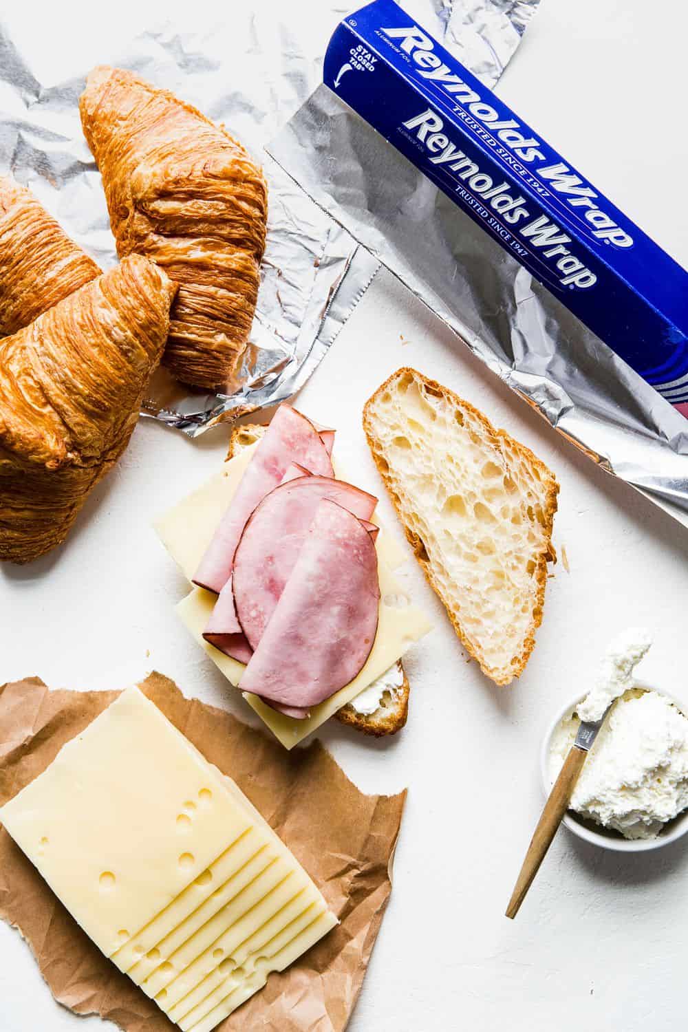 Monte Cristo Croissant Sandwich is a flaky croissant with melted Swiss cheese, decadent ham dipped in a raspberry jelly that will melt in your mouth with each bite! You will be in heaven with this sweet and savory sandwich! Monte Cristo Croissant Sandwich being made.