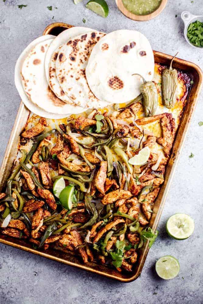 Sheet Pan Salsa Verde Chicken Fajitas are the tangy new way to enjoy a delicious taco Tuesday, or Wednesday, or any other day of the week. This healthy meal is made in minutes, leaving you with little cleanup, and tons of leftover salsa verde. Sheet Pan Salsa Verde Chicken Fajitas