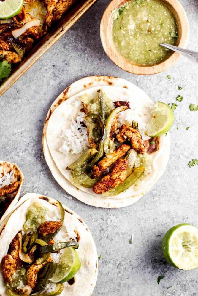 Sheet Pan Salsa Verde Chicken Fajitas are the tangy new way to enjoy a delicious taco Tuesday, or Wednesday, or any other day of the week. This healthy meal is made in minutes, leaving you with little cleanup, and tons of leftover salsa verde. Sheet Pan Salsa Verde Chicken Fajitas
