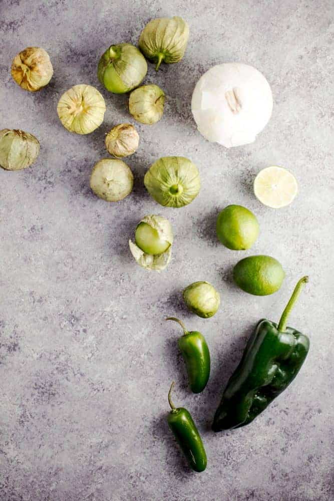 Sheet Pan Salsa Verde Chicken Fajitas are the tangy new way to enjoy a delicious taco Tuesday, or Wednesday, or any other day of the week. This healthy meal is made in minutes, leaving you with little cleanup, and tons of leftover salsa verde. Sheet Pan Salsa Verde Chicken Fajita ingredients laid out.