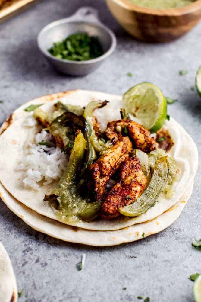 Sheet Pan Salsa Verde Chicken Fajitas are the tangy new way to enjoy a delicious taco Tuesday, or Wednesday, or any other day of the week. This healthy meal is made in minutes, leaving you with little cleanup, and tons of leftover salsa verde. Sheet Pan Salsa Verde Chicken Fajitas