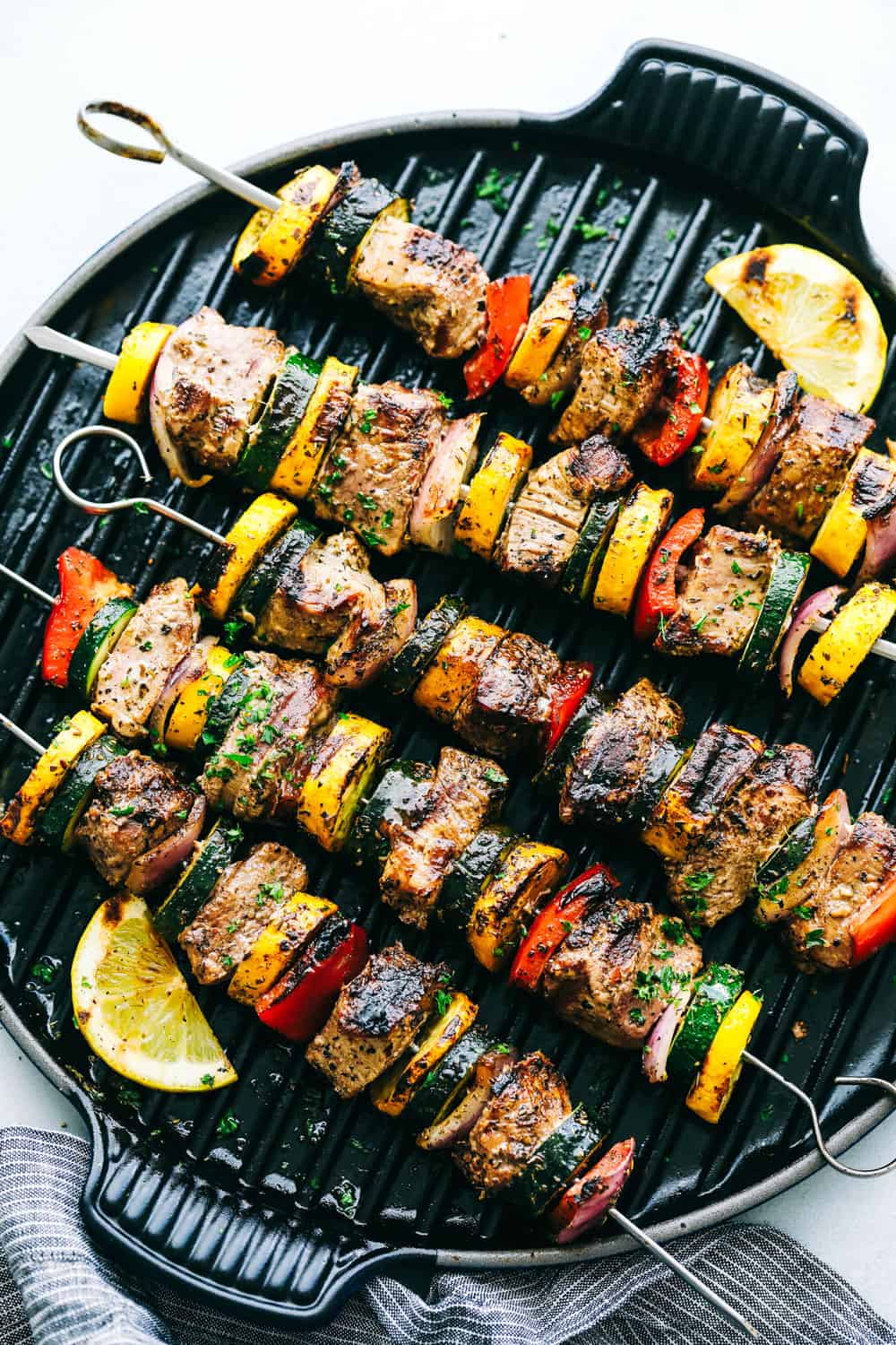 Grilled Tuscan Pork Skewersย are made with tender pork tenderloin cubes that are loaded with flavor, paired with fresh, summertime vegetables that enhance texture and flavor that will leave your tastebuds wanting more. This recipe will take your grilling to the next level this summer! Grilled Tuscan Pork Skewersย on a grill pan.