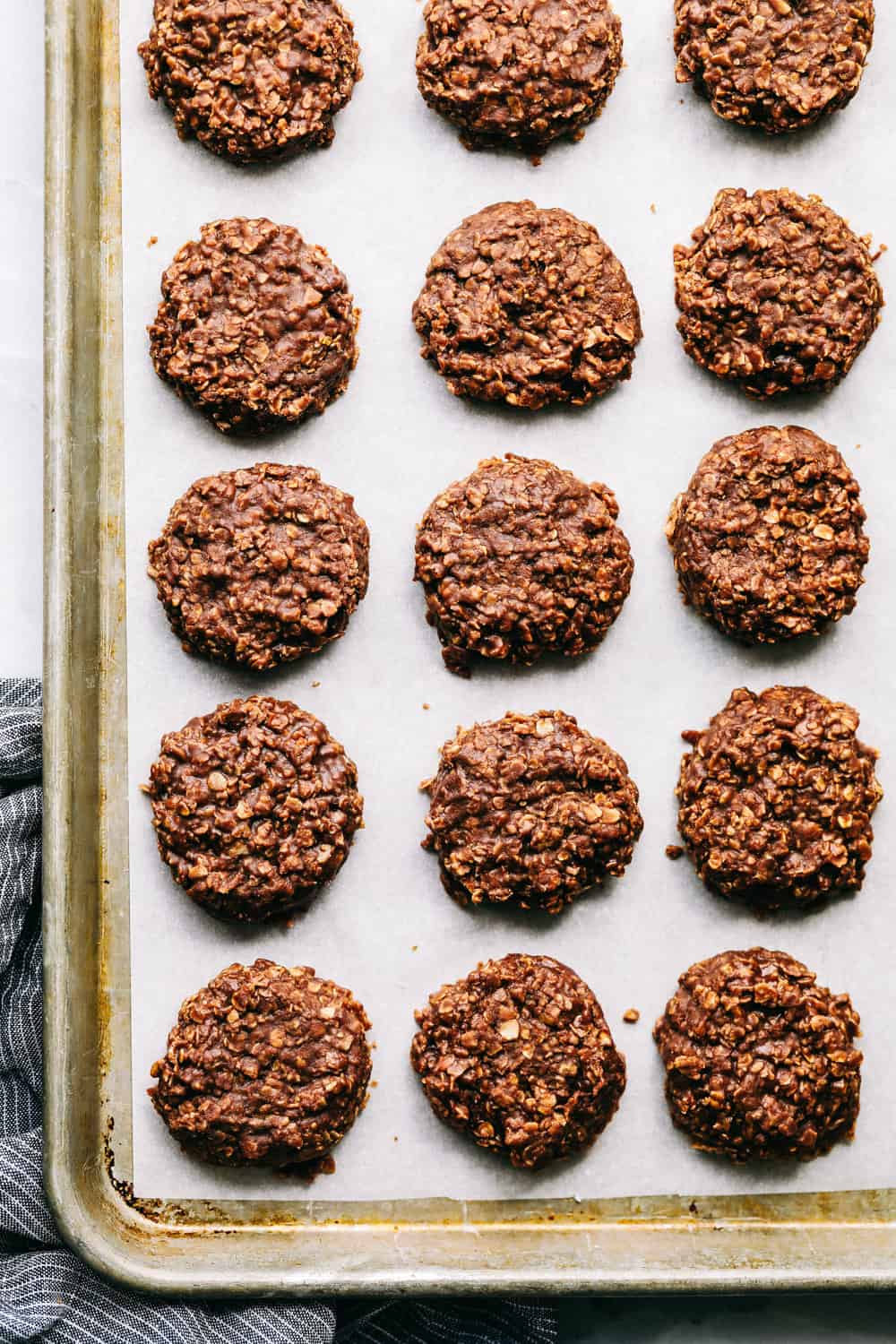 a quick and simple chocolaty, peanut butter cookie with a soft oatmeal texture that is a classic favorite! Ready in under 15 minutes! No Bake Cookies on a cookie sheet