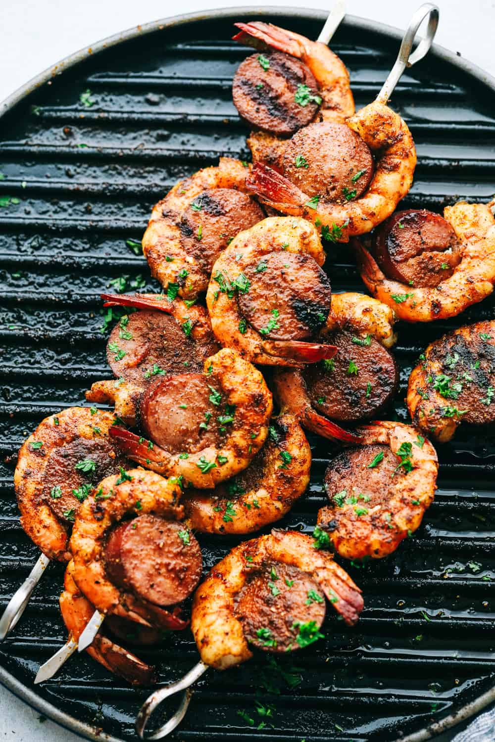 Easy and Amazing Cajun Shrimp and Sausage Skewers are simple to make and taste out of this world, good! Bold, flavorful Shrimp and Sausage make the perfect pairing on your next barbecue. Easy and Amazing Cajun Shrimp and Sausage Skewers on a grill pan.