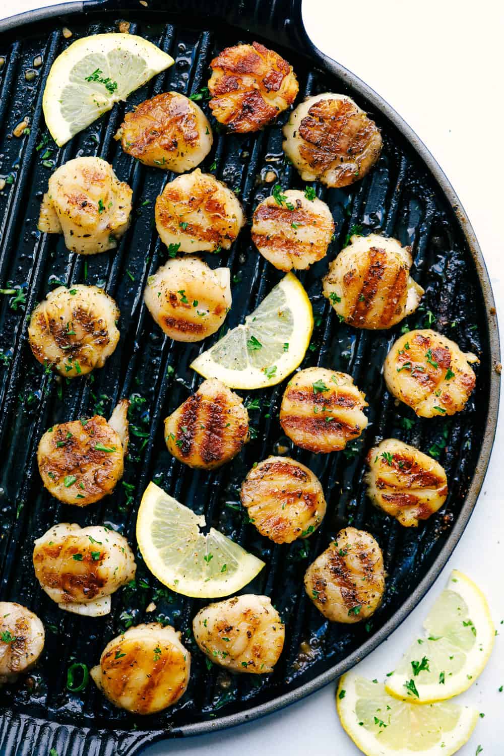 Grilled Lemon Garlic Scallops is an eloquent dishย marinated in the juices of a lemon, hint of garlic, wrapped inย olive oil with Italian seasonings all grilled to perfection! So simple to make and ready in minutes!ย Grilled Lemon Garlic scallops on the grill