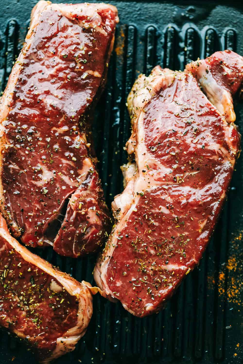 Perfectly Juicy Grilled Steak gets marinaded in the best flavor and grilled to juicy perfection! Learn all of the tips and tricks to grill the BEST steak every single time! Steak cooking on a grill pan.