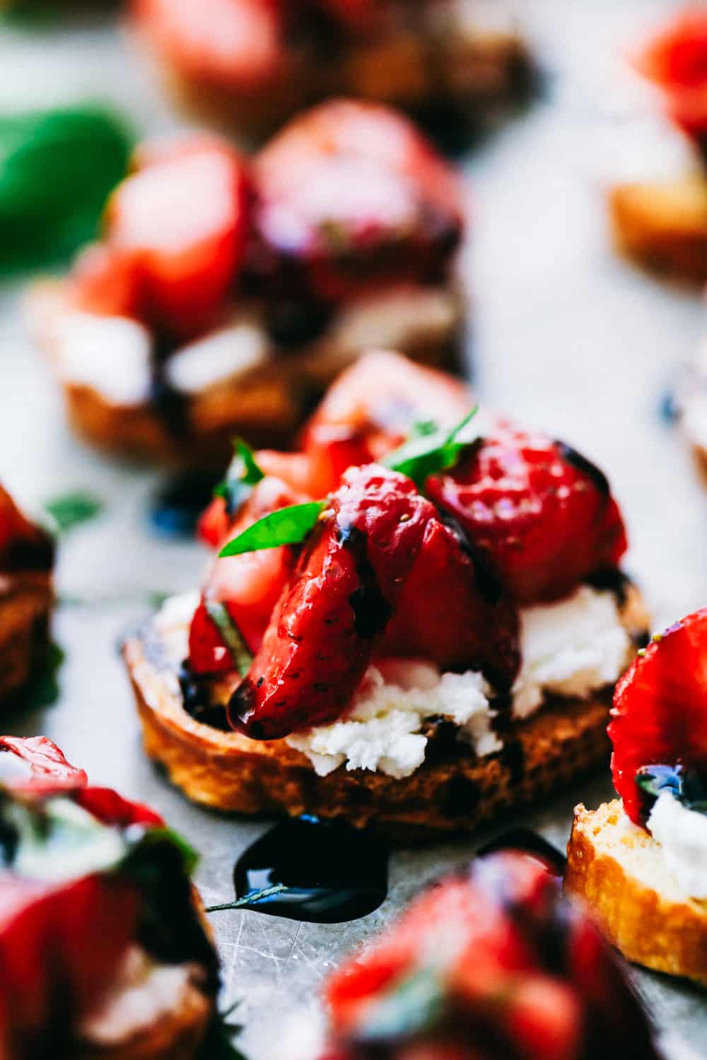 Easy Strawberry Bruschetta is an elegant appetizer that is vibrant and full of flavor! Fresh cut strawberries, warm goat cheese layered on a crunchy baguette slice, topped with a creamy balsamic glaze that melts in your mouth with every bite! strawberry bruschetta