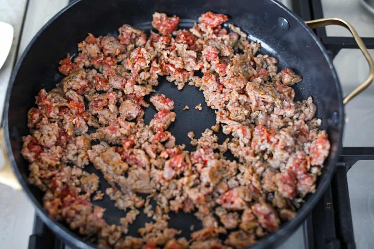 Baked spaghetti is the ultimate comfort food, with noodles that soak up all of the rich sauce as they finish cooking, making every bite extra flavorful. Plus, itโs a lifesaver on busy days. You can prep it ahead, pop it in the oven, and still have a cozy, home-cooked meal without the stress! Italian sausage cooking in a skillet.