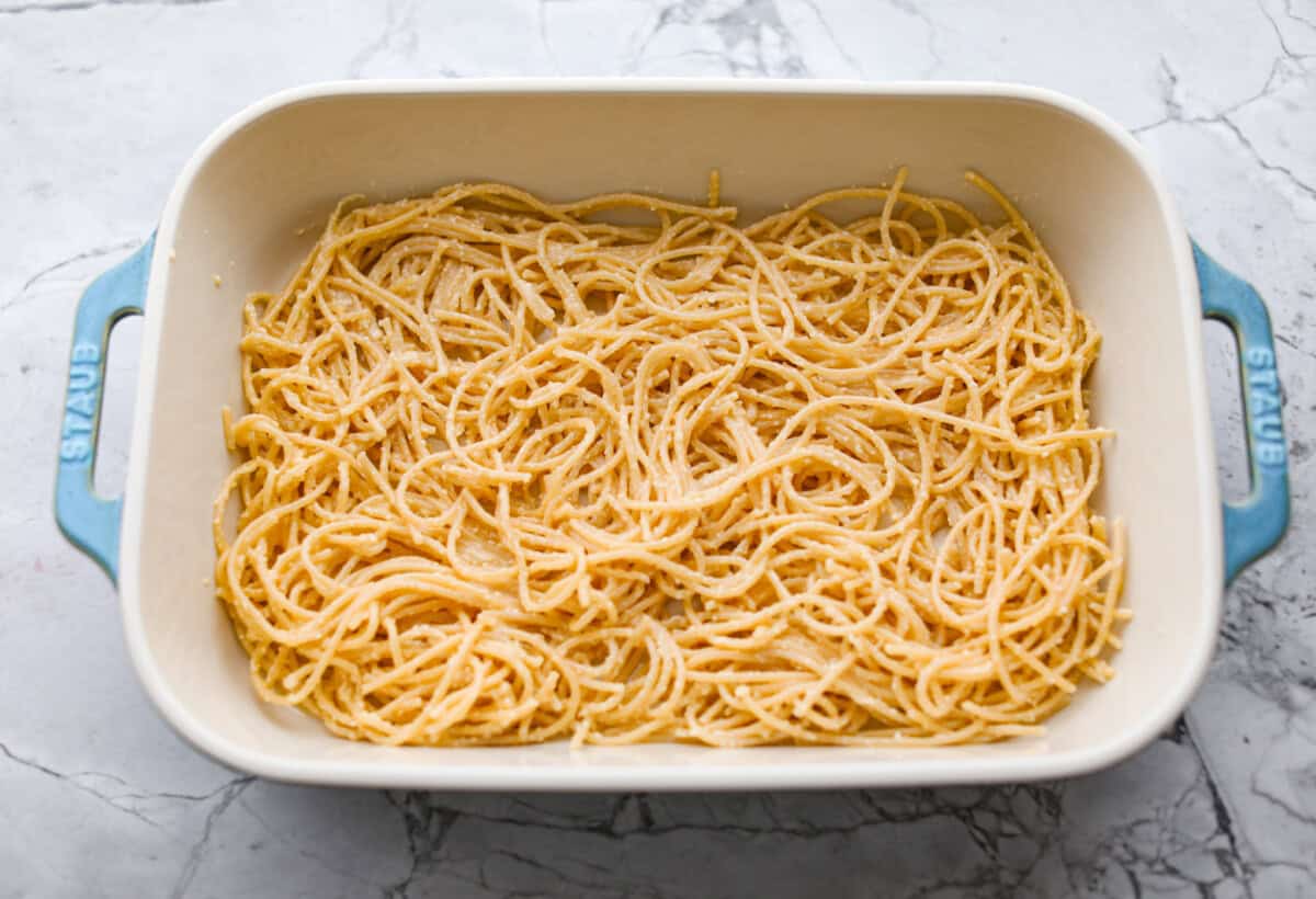 Baked spaghetti is the ultimate comfort food, with noodles that soak up all of the rich sauce as they finish cooking, making every bite extra flavorful. Plus, itโs a lifesaver on busy days. You can prep it ahead, pop it in the oven, and still have a cozy, home-cooked meal without the stress! Layer of noodles in the bottom of a baking dish.