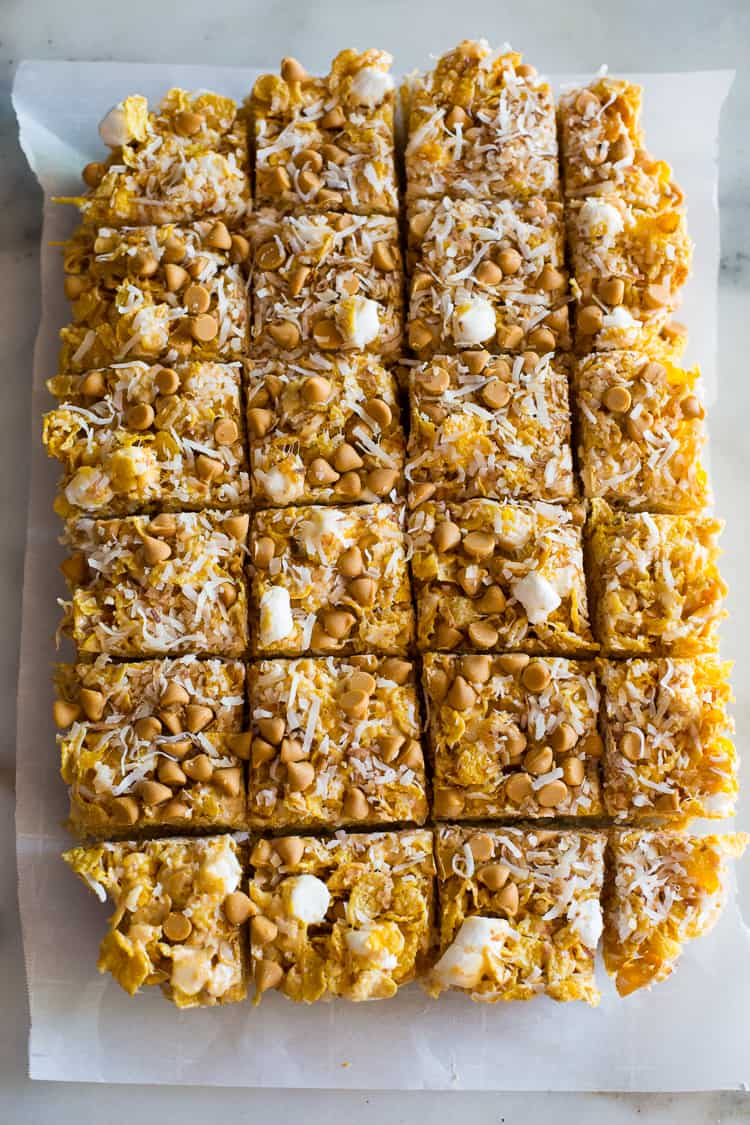 No Bake Butterscotch Bars are the perfect fast summer treat! This easy recipe is made with marshmallows, cornflakes, coconut, and butterscotch chips. Butterscotch bars cut into servings.