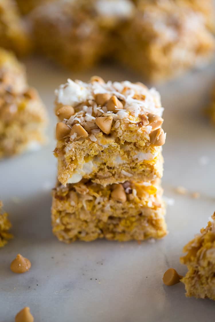 No Bake Butterscotch Bars are the perfect fast summer treat! This easy recipe is made with marshmallows, cornflakes, coconut, and butterscotch chips. Butterscotch bars in a stack.