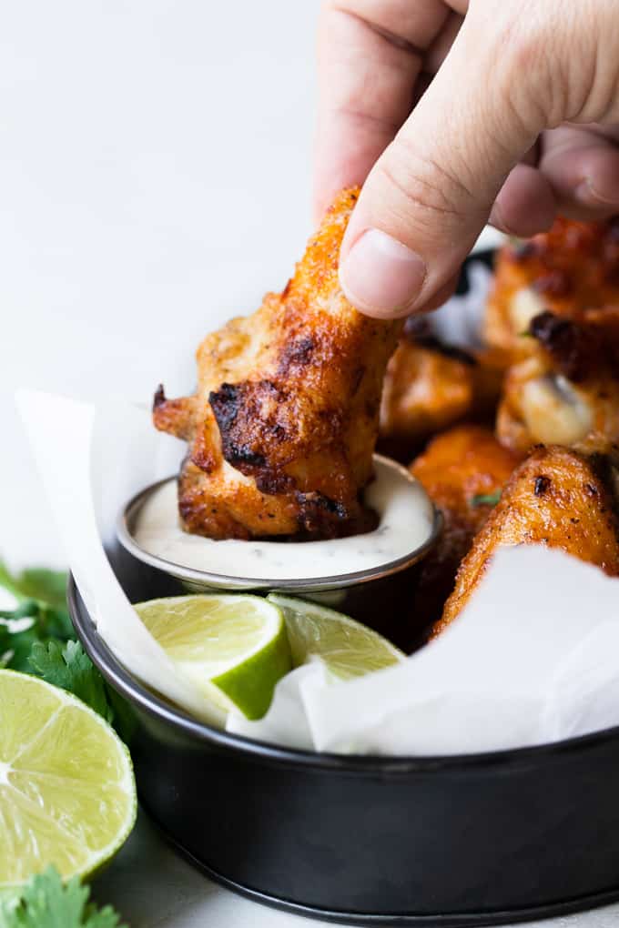 Chili Lime Chicken Wings. These BAKED chicken wings are simple to make and loaded with flavor thanks to a mixture of chili sauce and fresh lime juice and zest. The skin is so crispy on these you won't believe they aren't fried! Chili Lime Chicken Wings dipped in sauce