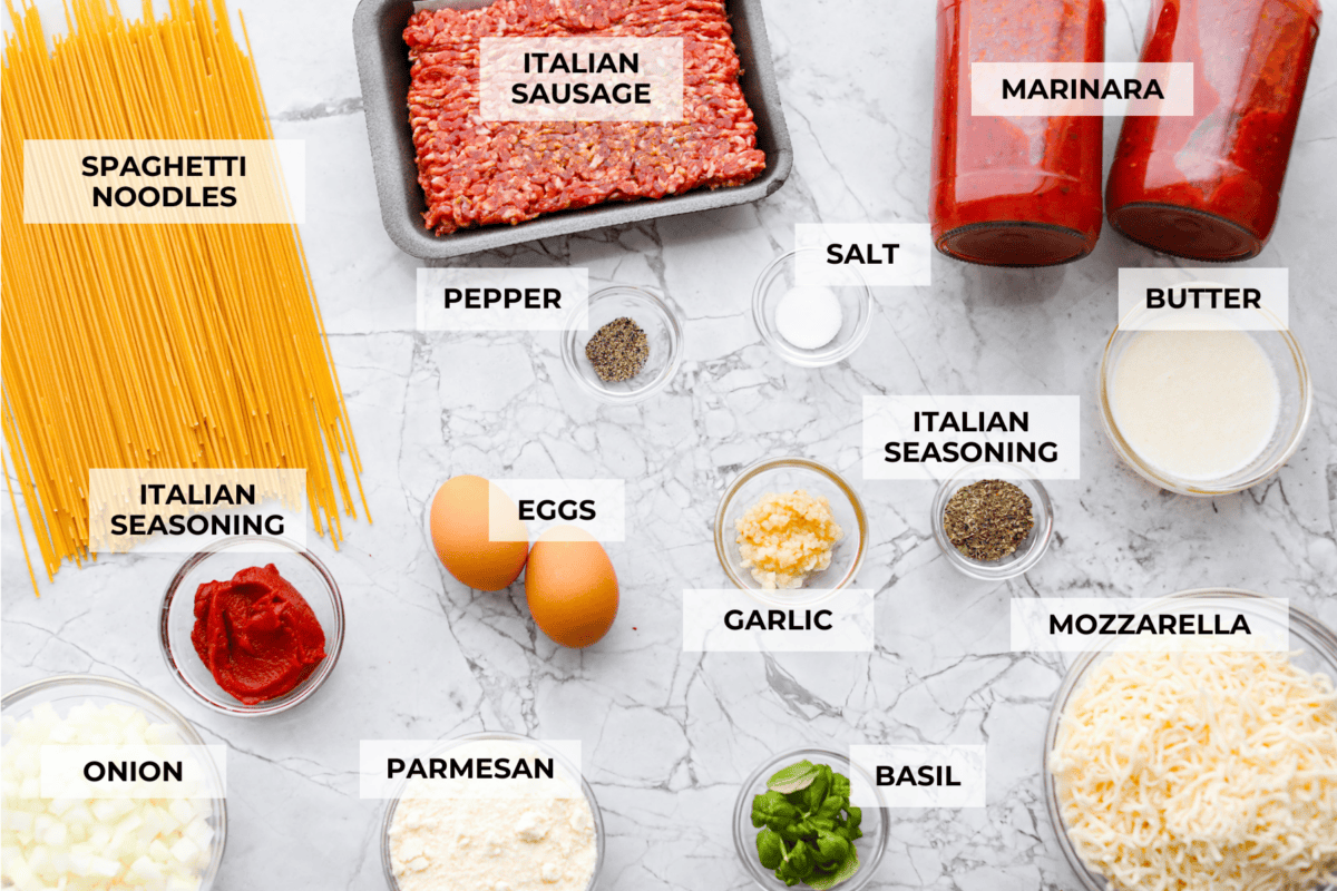 Baked spaghetti is the ultimate comfort food, with noodles that soak up all of the rich sauce as they finish cooking, making every bite extra flavorful. Plus, itโs a lifesaver on busy days. You can prep it ahead, pop it in the oven, and still have a cozy, home-cooked meal without the stress! Overhead shot of labeled baked spaghetti ingredients.