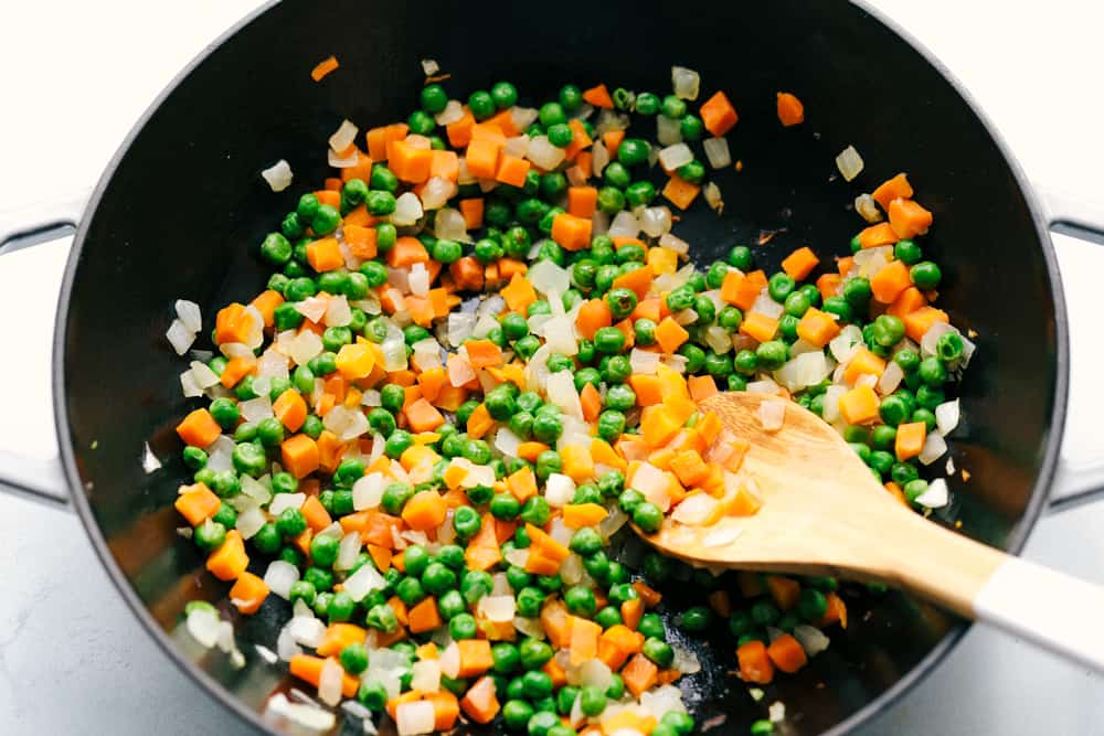 This Easy Fried Rice has always been one of the most-loved recipes on my site! I have made different versions, but this classic recipe is the one everyone keeps coming back to because it's so easy and delicious! Veggies cooking in a skillet.