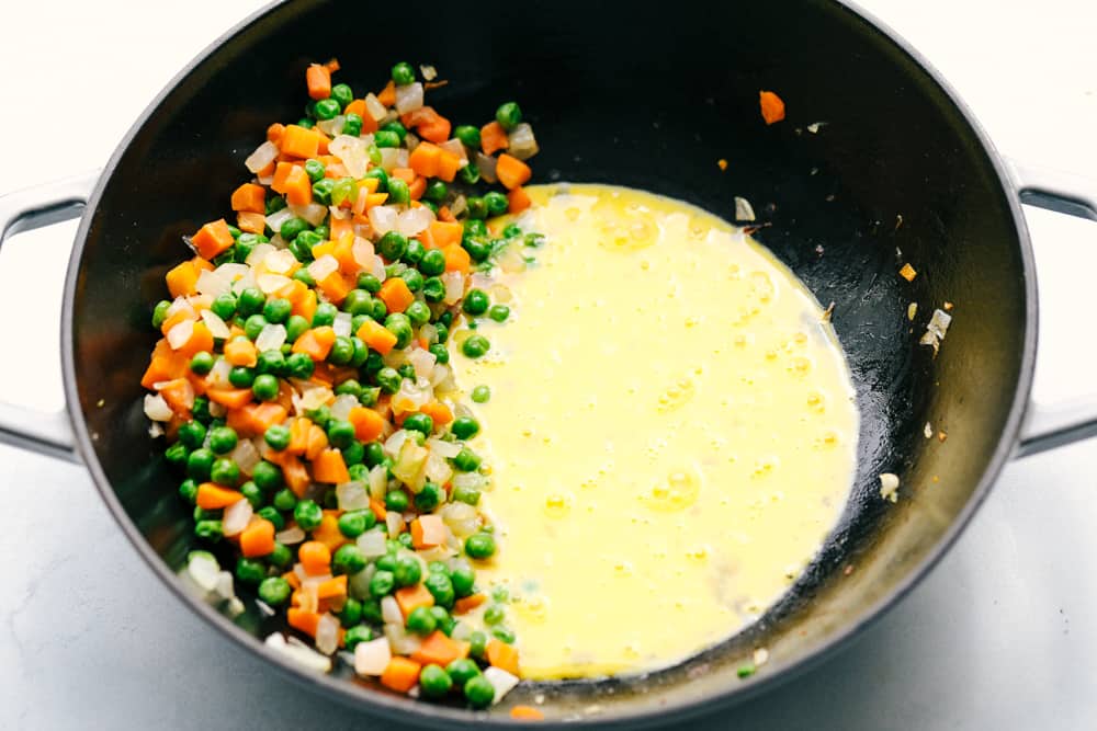 This Easy Fried Rice has always been one of the most-loved recipes on my site! I have different versions, but this classic is the one everyone keeps coming back to. Veggies all pushed to one side of a skillet and eggs cooking on the other side.