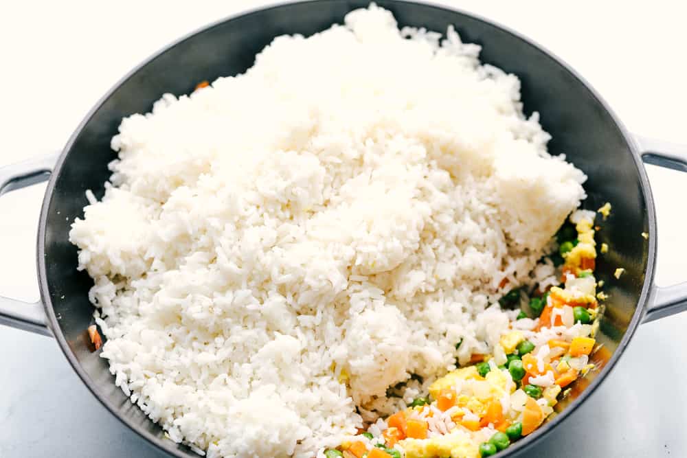 This Easy Fried Rice has always been one of the most-loved recipes on my site! I have made different versions, but this classic recipe is the one everyone keeps coming back to because it's so easy and delicious! Day old rice added to the skillet with the cooked eggs and veggies.