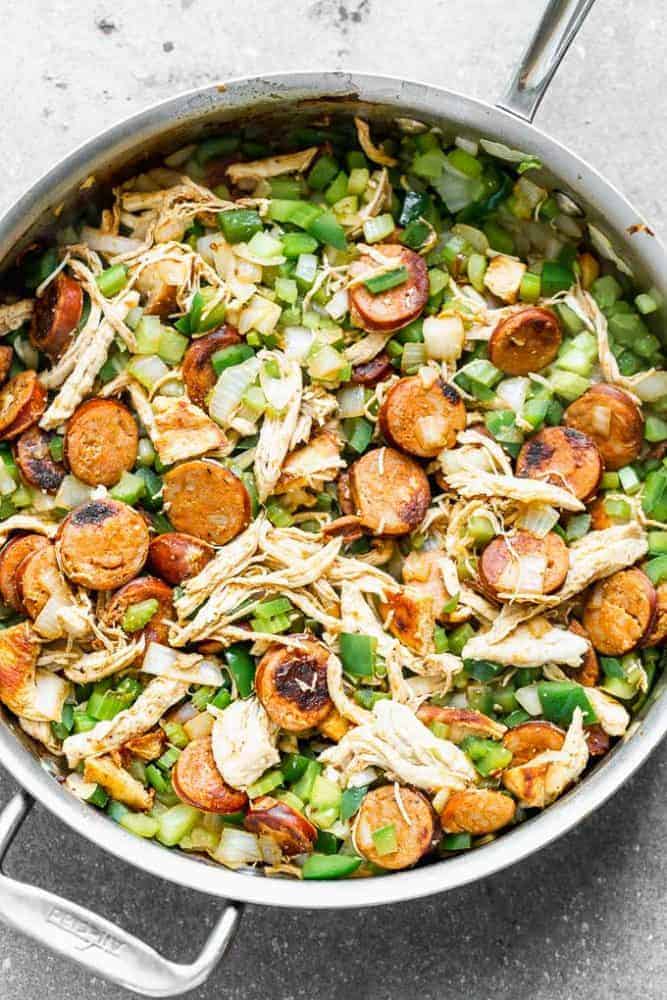 Thisย Easy Jambalaya Recipeย is packed with spicy andouille sausage, shredded chicken, sweet shrimp, and of course, plenty of vegetables and rice. Itโs the perfect one-pot meal for busy nights! Easy jambalaya