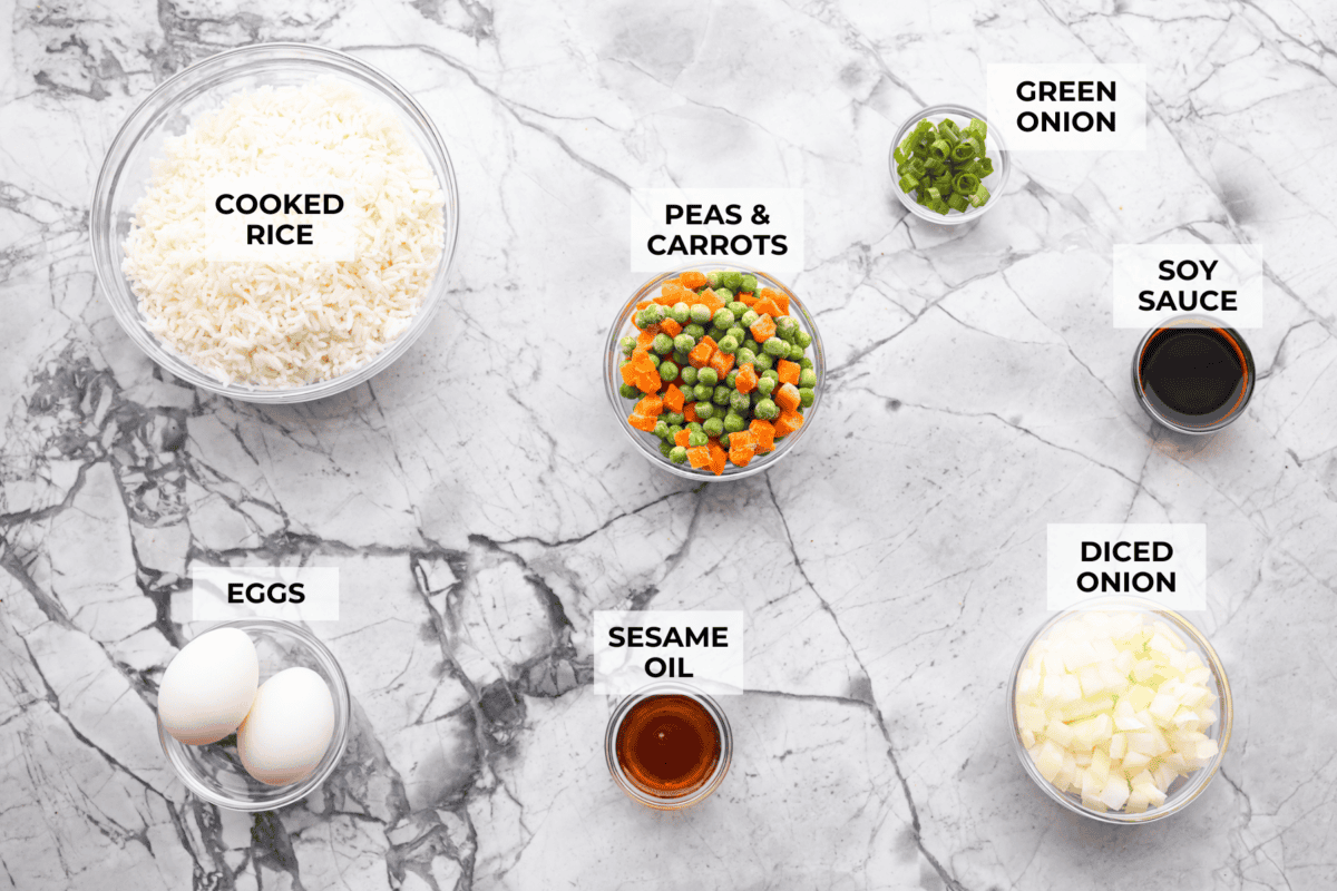 This Easy Fried Rice has always been one of the most-loved recipes on my site! I have made different versions, but this classic recipe is the one everyone keeps coming back to because it's so easy and delicious! Overhead shot of labeled ingredients.
