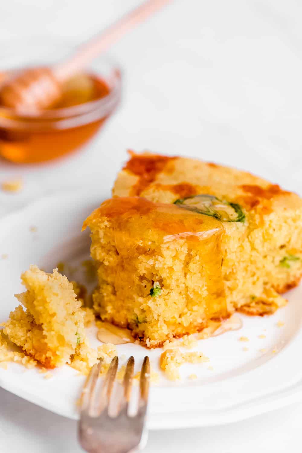 Jalapeño Cornbread is filled with spicy jalapeno peppers, cheddar cheese, and corn. This savory bread is moist, tender, and so easy to throw together. Serve it at your next barbecue or chili kick off! Jalapeno cornbread sliced.