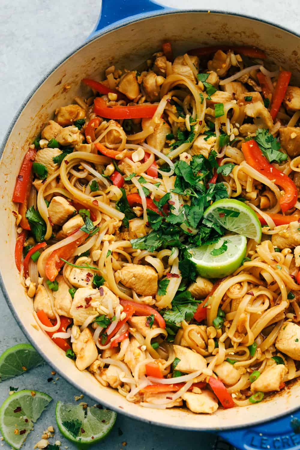 Pad Thai is a popular Thai dish made with rice noodles, chicken, peanuts, scrambled eggs, and bean sprouts, all tossed in a delicious sweet and spicy sauce. It is everyone's favorite! A close up of Pad Thai in a pan.