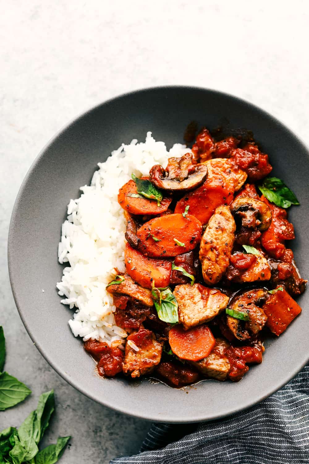 Skillet Pork Cacciatore is madeย with tender, slow roaster pork, mixed with garden vegetables and mushrooms, Italian herbs all simmered together for an easy 30 minute mealย that will be lovedย at the dinner table. ย An Italian favorite made with simpleย ingredients!ย skillet pork cacciatore over rice