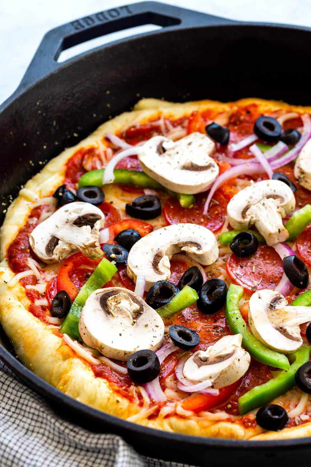 This Skillet Pizza is made supreme style, topped with a colorful mix of pepperoni, bell peppers, onions, mushrooms, and olives. The pizza dough is cooked in a hot cast-iron skillet to ensure a crispy crust. Grab a hot slice of cheesy homemade pie, it will disappear fast! Make a cast iron pizza