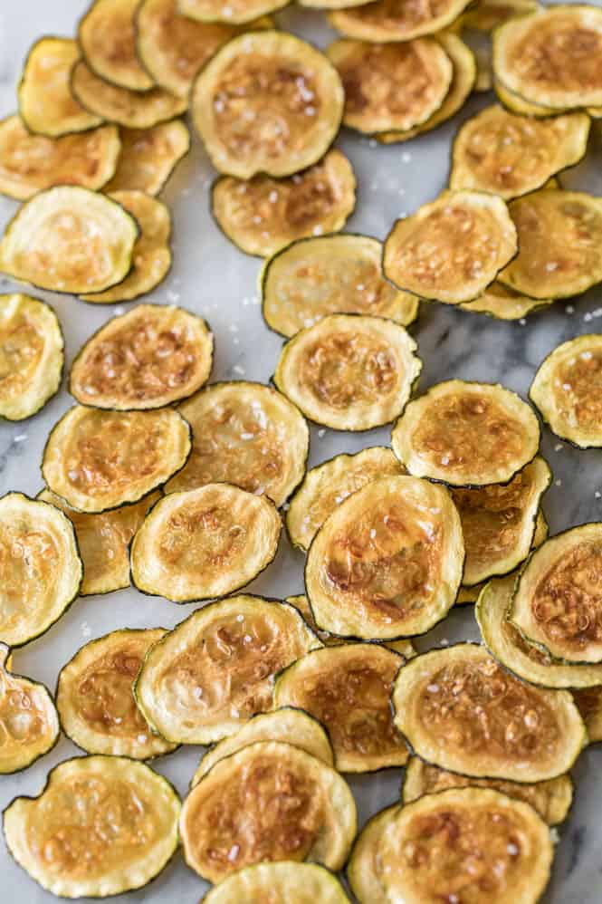 Need something to do with all of that fresh zucchini in your garden? I highly recommend you try this simple recipe for homemadeย Zucchini Chips! Simple to make and baked in the oven, these are a light, fun snack! Zucchini chips that are baked, seasoned and ready to eat.