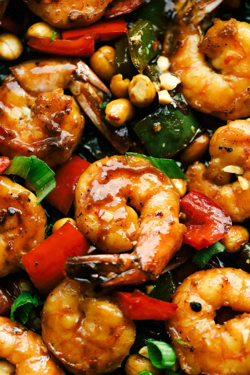 Awesome Kung Pao Shrimp is filled full of flavor with large shrimp, tender bell peppers, nutty peanuts cooked together with a sweet and spicy sauce. Ready in under 20 minutes! Kung Pao shrimp