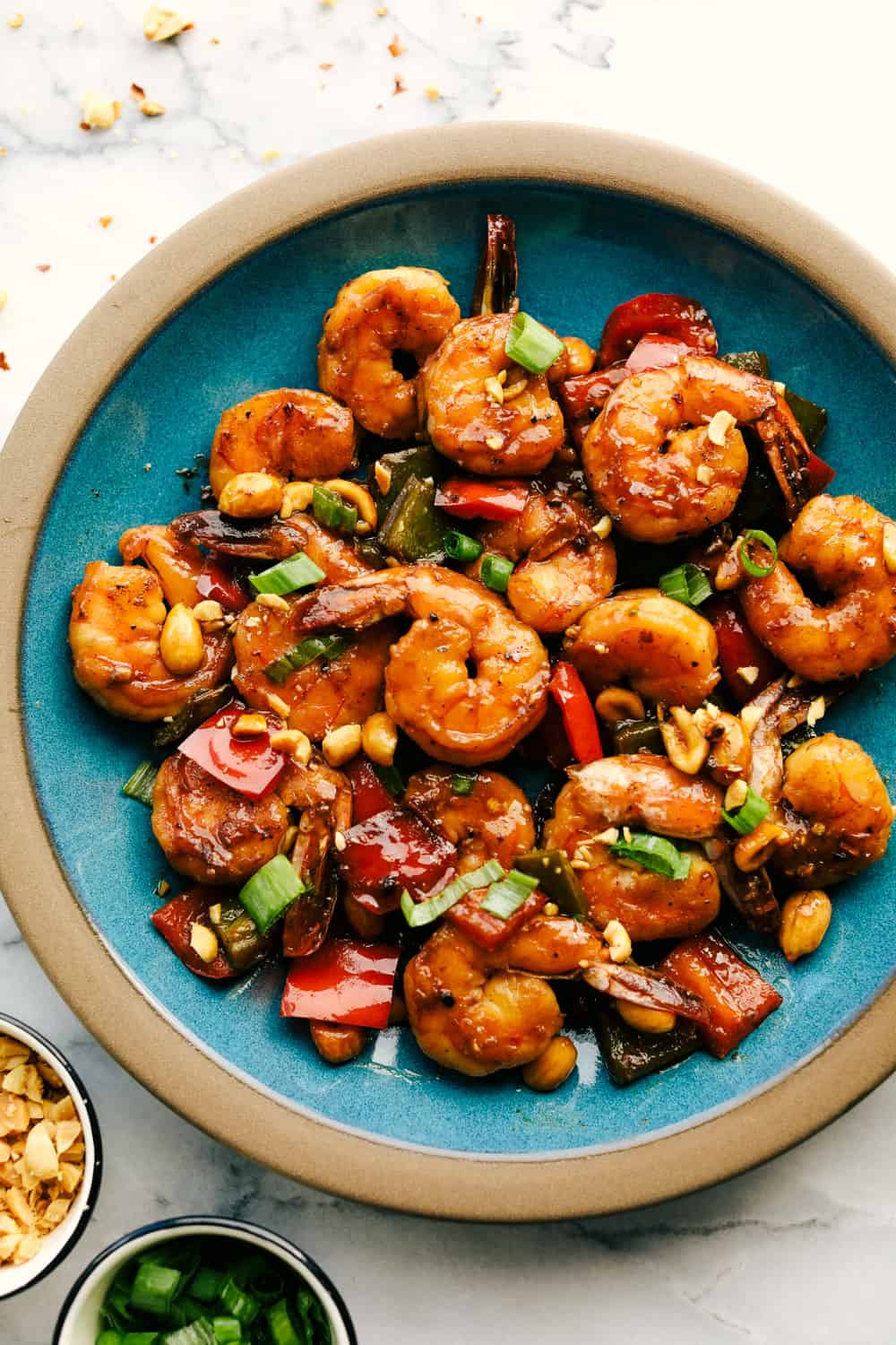 Awesome Kung Pao Shrimp is filled full of flavor with large shrimp, tender bell peppers, nutty peanuts cooked together with a sweet and spicy sauce. Ready in under 20 minutes! Kung Pao shrimp