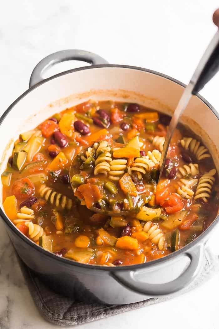 This easy Minestrone Soup recipe is loaded with vegetables, beans and pasta and flavored with Italian herbs for an easy weeknight dinner the whole family will love! #soup #recipe #minestrone minestrone soup in pot