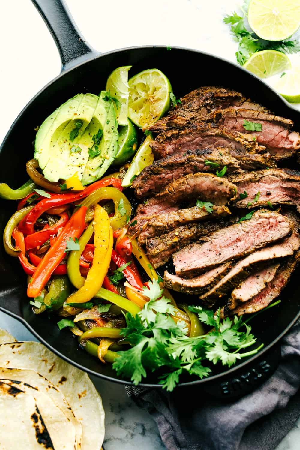 Amazing Steak Fajitas have tender marinated, juicy steak with colorful bell peppers wrapped in a soft shell tortilla topped with all your favorites. A complete dinner in 45 minutes! steak fajitas