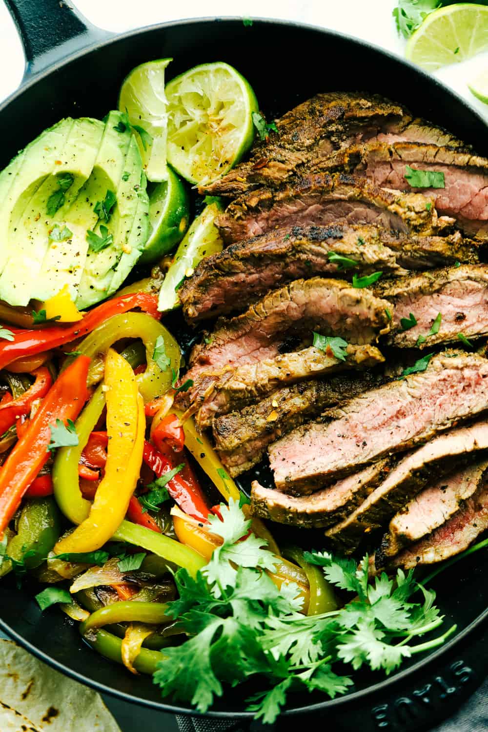 Amazing Steak Fajitas have tender marinated, juicy steak with colorful bell peppers wrapped in a soft shell tortilla topped with all your favorites. A complete dinner in 45 minutes! steak fajitas