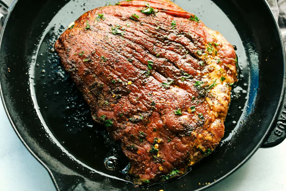 Amazing Steak Fajitas have tender marinated, juicy steak with colorful bell peppers wrapped in a soft shell tortilla topped with all your favorites. A complete dinner in 45 minutes! flank steak in a skillet