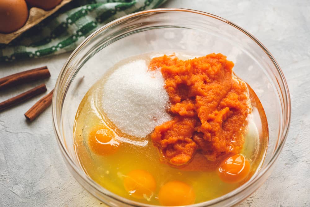 This Pumpkin Cake is the most amazing pumpkin cake you will ever make! ย Perfectly spiced and moist and topped with the most epic cream cheese whipping cream frosting! pumpkin cake ingredients in a bowl
