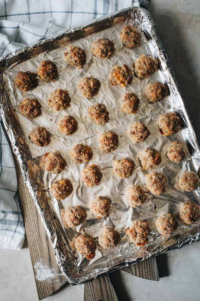 Perfect party appetizers make the holidays sweeter and full of savory memories. These Easy Sausage Balls are a southern serving staple with simple ingredients or sausage, cheddar cheese, Bisquick, and olive oil. Easy Sausage Balls