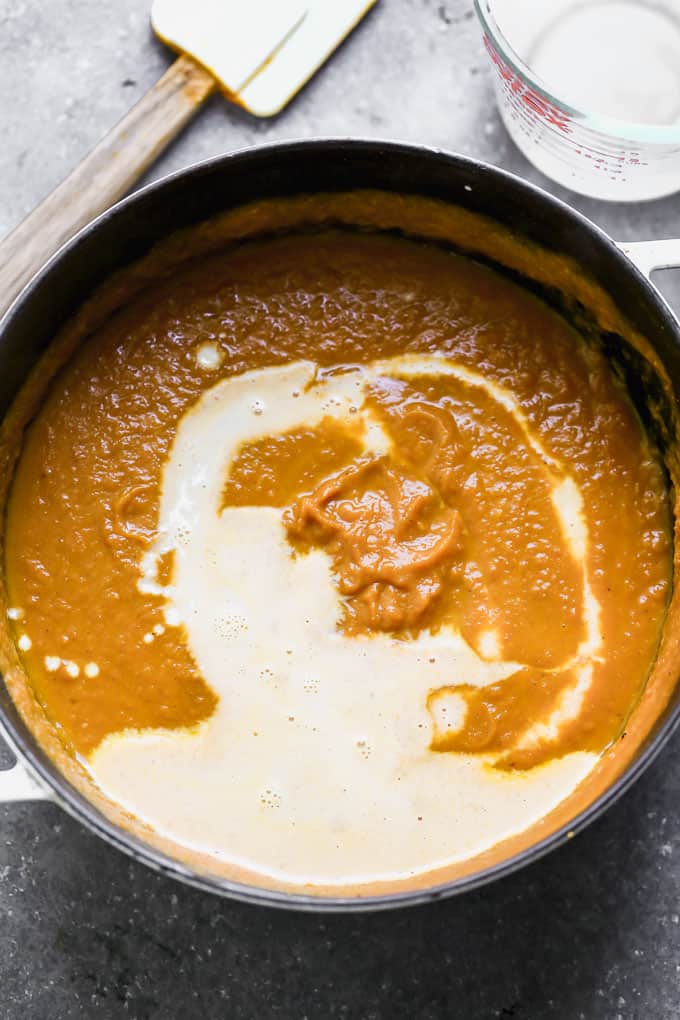 This Creamy Pumpkin Soup is packed with pumpkin flavor, a touch of sweetness, and velvety smooth. It's the perfect cozy fall soup, and it only takes 30 minutes to throw together! pumpkin soup in the pot