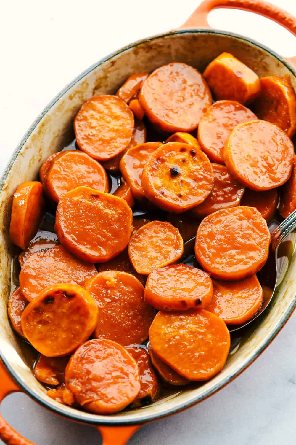 Candied Sweet Potatoes are just that, sweet and tender, juicy, bright orange sweet potatoes that will warm your home and melt in your mouth! Only 3 ingredients is all you need! Candied sweet potatoes baked