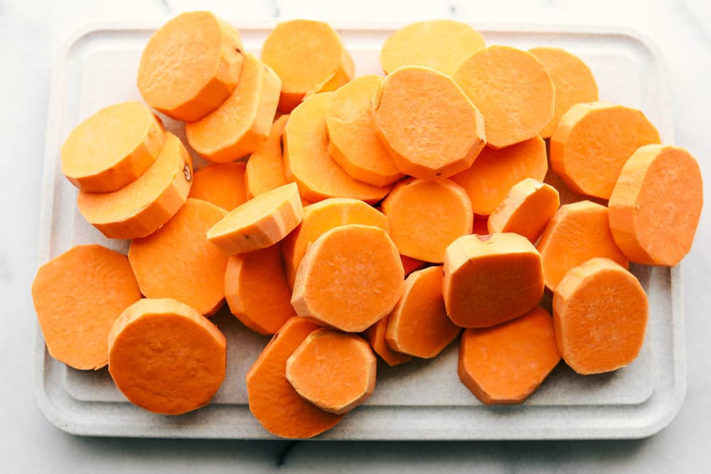 Candied Sweet Potatoes are just that, sweet and tender, juicy, bright orange sweet potatoes that will warm your home and melt in your mouth! Only 3 ingredients is all you need! sweet potatoes cut up