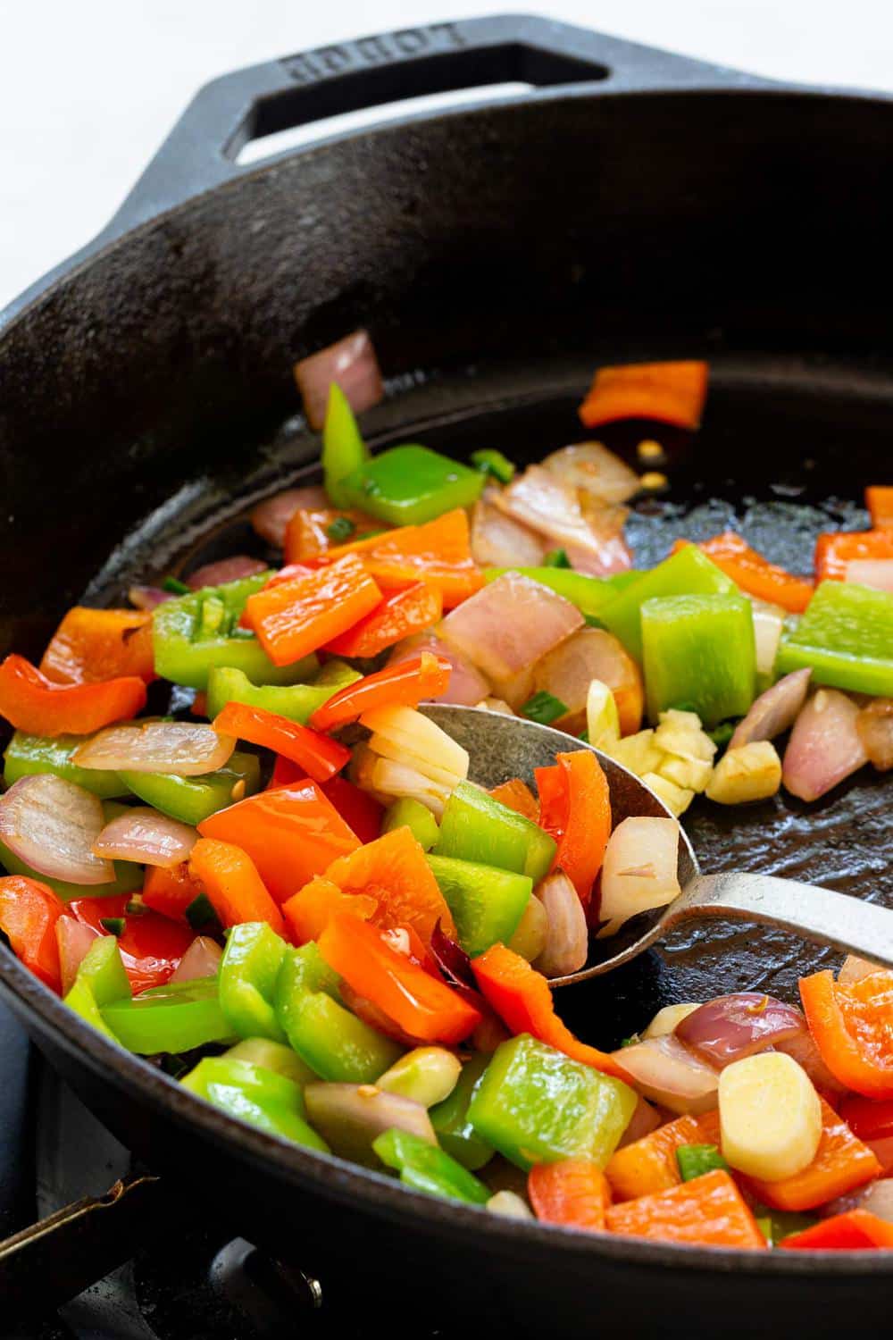 Skillet Potatoes are an easy side dish to make in one pan! The potatoes areย sautรฉedย with peppers and onions, then steamed until tender for flavorful spuds with each bite. sauteing vegetables in a skillet