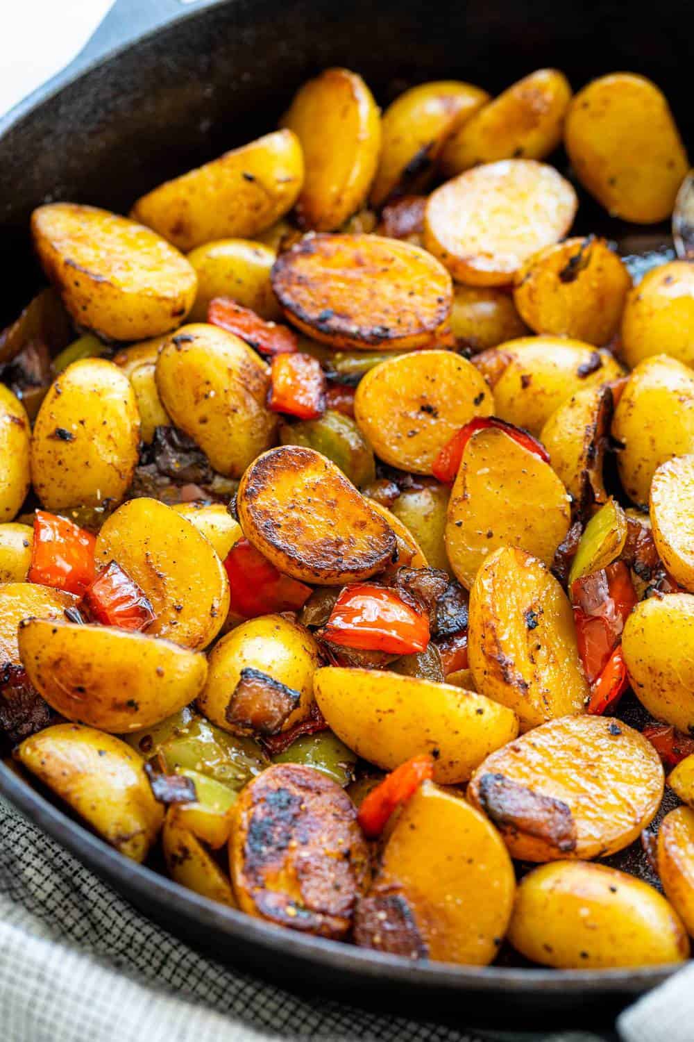 Skillet Potatoes are an easy side dish to make in one pan! The potatoes areย sautรฉedย with peppers and onions, then steamed until tender for flavorful spuds with each bite. Skillet Potatoes with Peppers