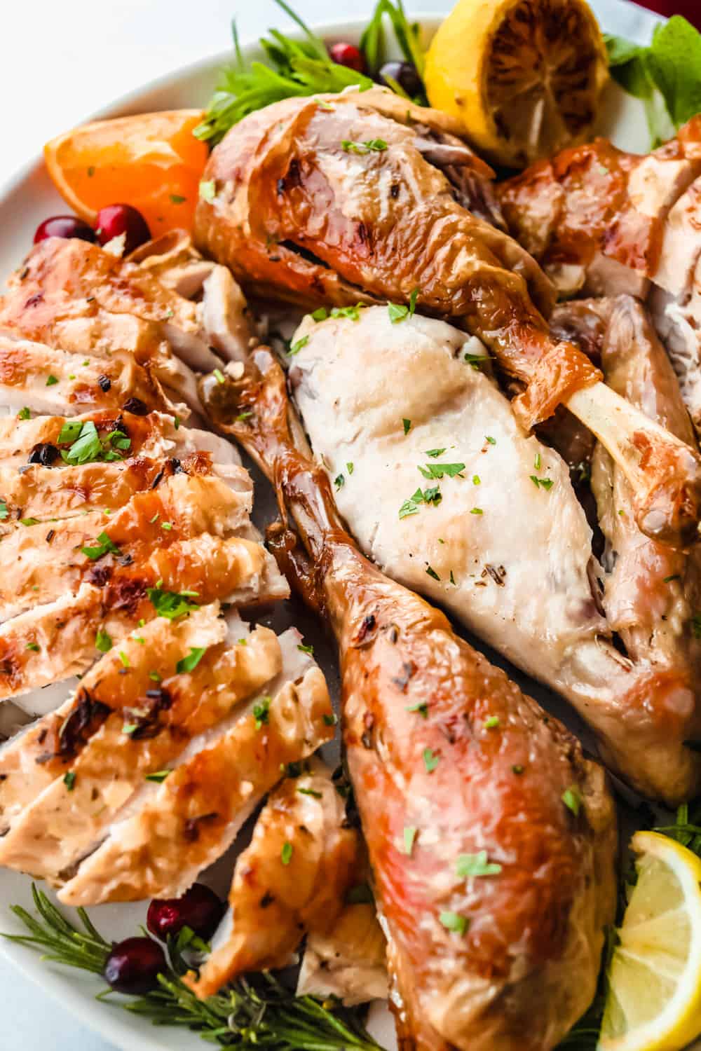 Turkey Brine creates aย tender, moist and juicy turkey withย sweet citrusy flavoring and a hint of spice all submerged in a water bath for your turkey to soak from the inside-out. Make your turkey irresistible this holiday season! Baked turkey sliced into pieces on a plate
