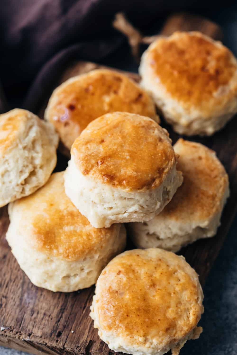 Delicious buttermilk biscuits are deceptively simple to make. They are flaky, melt in your mouth and you won't stop eating them. They stand tall and have the best layers.ย Buttermilk biscuits piled one on top of the other